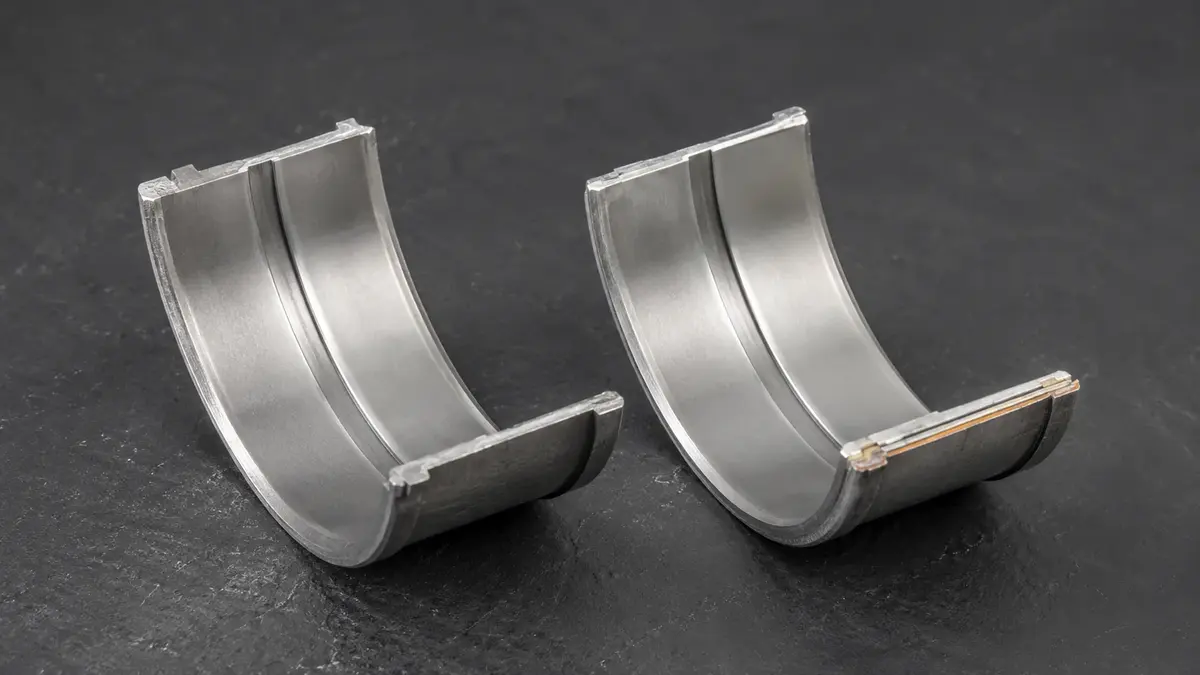 Steel-backed connecting-rod bearing shells — a precision-machined plain bearing despite the "rod bearing" name